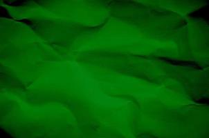 Green background and wallpaper by crumpled paper texture. photo