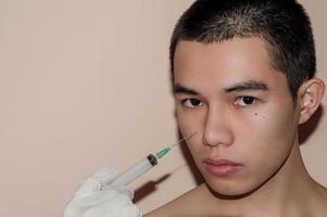 Young man with beautiful face after treatment from acne and pimple. photo