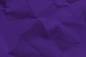 Fondo púrpura y vintage por textura de papel arrugado. foto