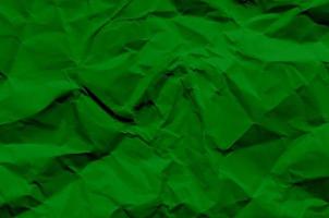 Fondo verde y papel tapiz de textura de papel arrugado. foto