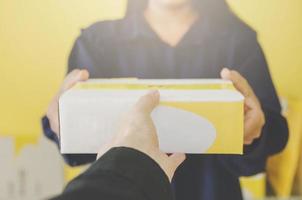 A human hand holding parcel and mailbox for delivery and shipping. photo