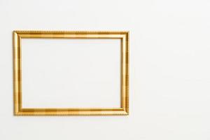 Empty picture frame on white wall background photo