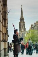 Street performer playing bagpipes photo