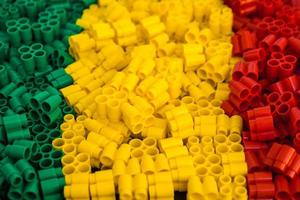 Plastic bricks of red, yellow and green as a background texture photo