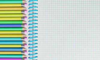 Top view of notebook with multicolored pencils photo