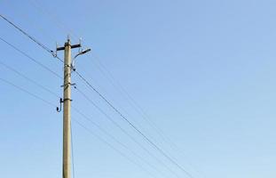 Power electric pole with line wire on colored background close up photo