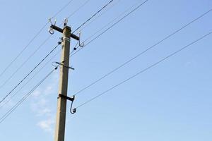 Power electric pole with line wire on colored background close up photo