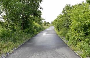 Beautiful empty asphalt road in countryside on colored background photo