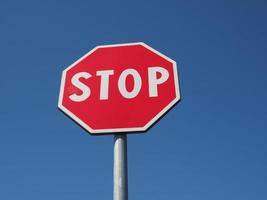 Stop sign over blue sky photo