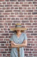 Portrait of a beautiful young woman on a background of red bricks photo