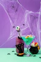 Scary colorful Halloween cocktails with party decorations on purple photo