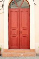 Bright red door and strairs outdoors on the street photo