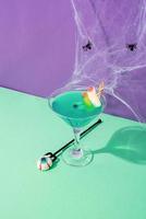 Scary colorful Halloween cocktails with party decorations on purple photo