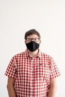 Young man putting on a protective mask photo