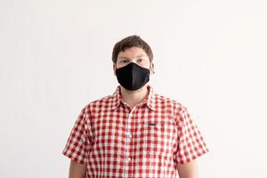 Young man putting on a protective mask photo