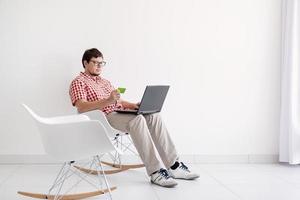 Young man shopping on internet with laptop photo