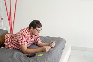 Young man shopping on internet with tablet photo