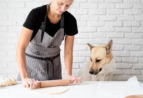 Woman kneading dough at home photo