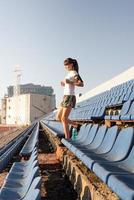 Teenager girl working out at the staduim running down the stairs photo