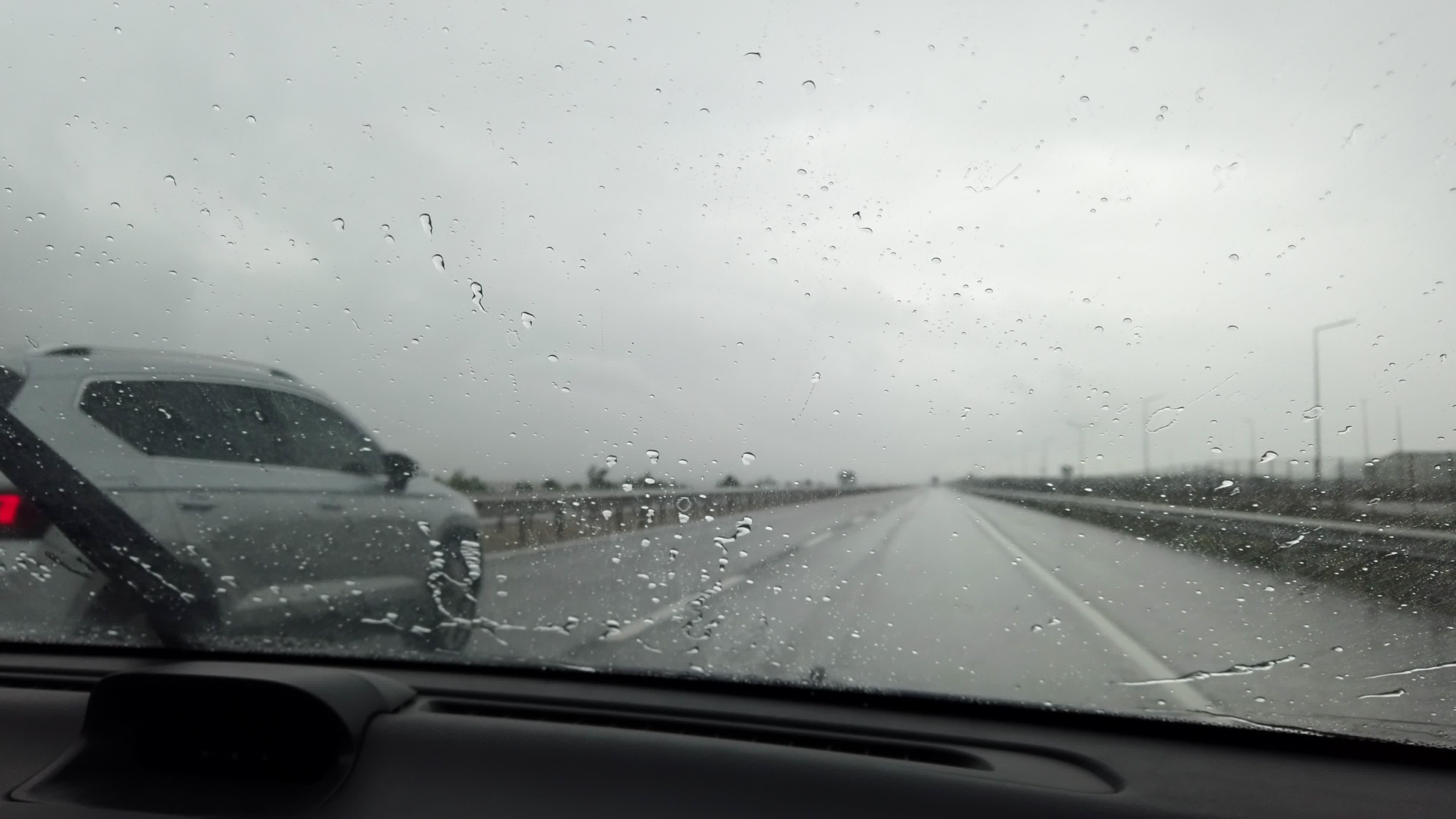 Pouring rain from interior of a car when going on the road 3343458