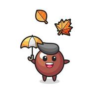 cartoon of the cute chocolate ball holding an umbrella in autumn vector