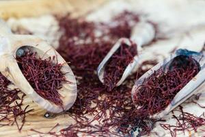 Saffron threads on olive wood photo