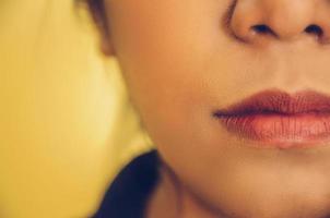 Beauty face of woman by applying lipstick on mouth by cosmetics. photo