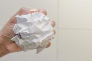 No idea and fail concept, Human hand holding crumpled paper and trash. photo