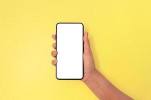 A hand holding smartphone with white screen background. photo