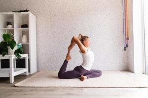 Young attractive woman practicing yoga, wearing sportswear photo