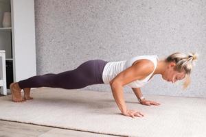 Young attractive woman practicing yoga, wearing sportswear photo