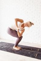 Blonde woman practising yoga at home photo