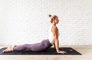 Young attractive woman practicing yoga, wearing sportswear photo