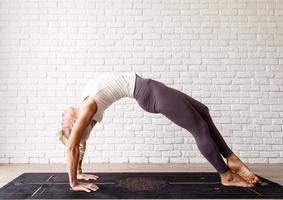 Young attractive woman practicing yoga, wearing sportswear photo