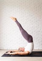 Young attractive woman practicing yoga, wearing sportswear photo