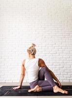 Young attractive woman practicing yoga, wearing sportswear photo