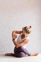 Young attractive woman practicing yoga, wearing sportswear photo