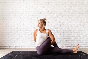 Young attractive woman practicing yoga, wearing sportswear photo