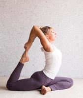 Young attractive woman practicing yoga, wearing sportswear photo