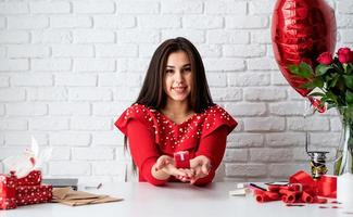 Woman wrapping gifts for Valentine's Day photo