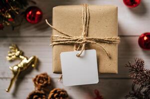 Gift box with a small gift on a white wooden background photo