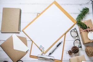 Clipboard placed on a white wooden table with glasses photo