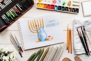 Top view of a watercolor art Happy Hanukkah photo