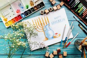 Top view of a watercolor art Happy Hanukkah photo