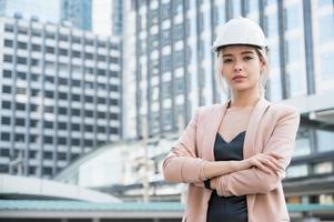 Portrait of pretty young civil engineer woman on construction photo