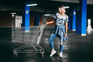 Woman with shopping carts in a parking lot photo