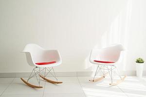 Krasnodar, Russia 2021- Modern light and airy interior of white room with chairs and empty background photo