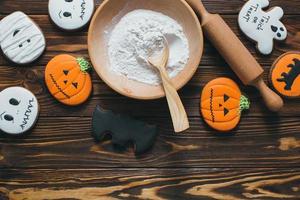 Fresh halloween gingerbread cookies on wooden table. photo
