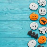 Fresh halloween gingerbread cookies on blue wooden table. photo
