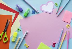 Frame of different stationery on blue background photo